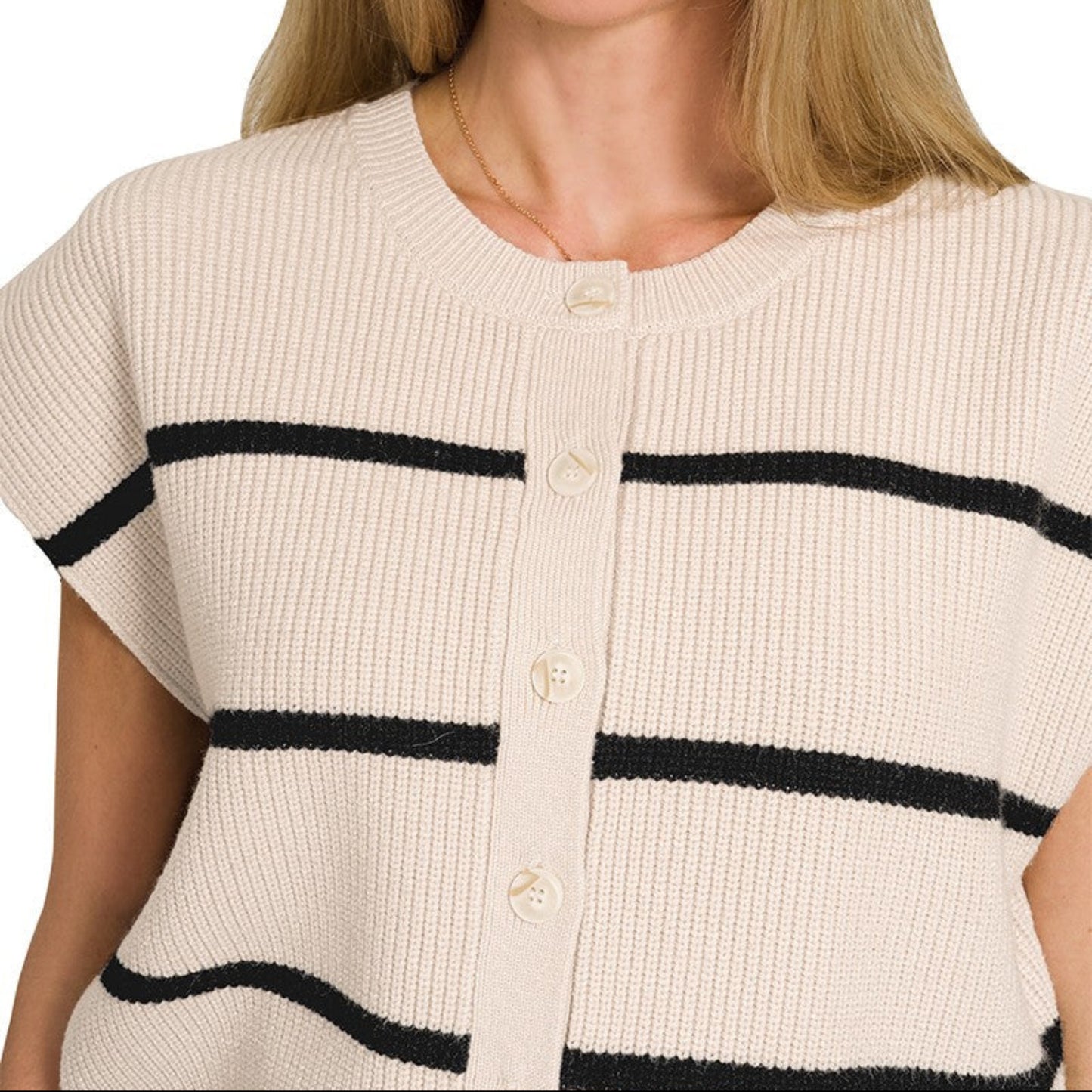 Woman wearing a sand beige cardigan with black stripes on a white background