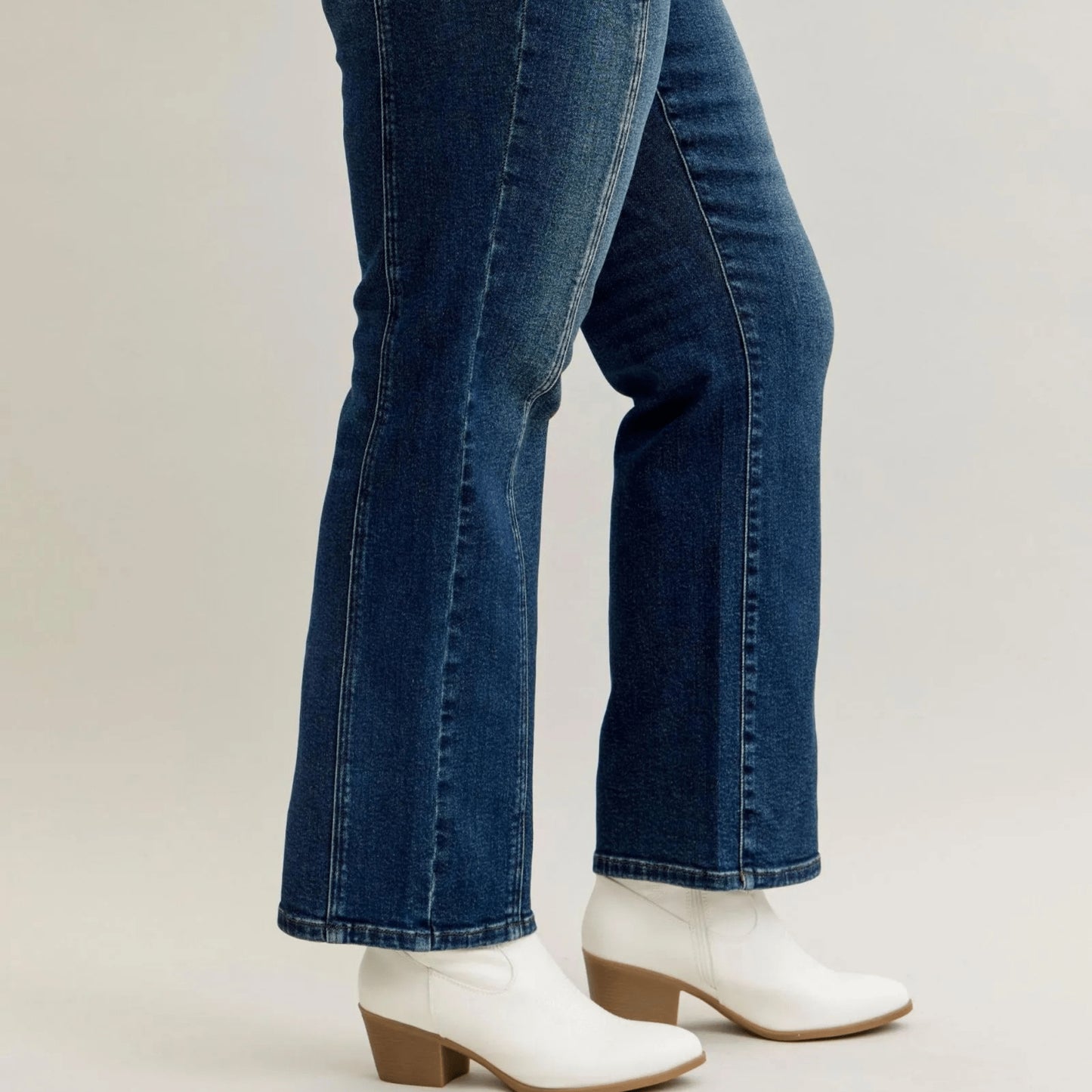 Lifestyle shot of dark wash straight-leg jeans styled with a tucked-in top for a chic look.
