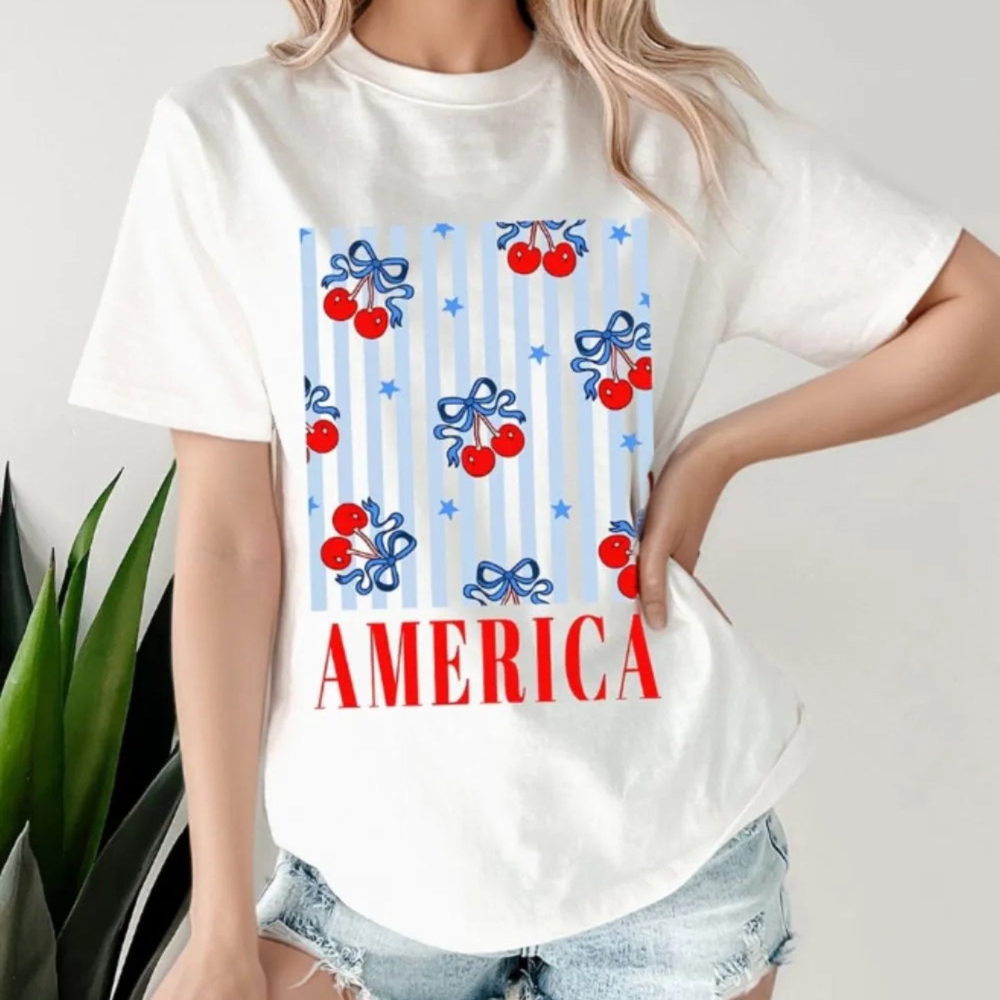 Bow Cherry AMERICA Graphic Crewneck Patriotic T-Shirt in White - Lifestyle View 1
