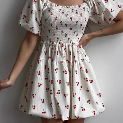 Puff Sleeve Cherry Print Smocked Mini Dress in White - Lifestyle View 1