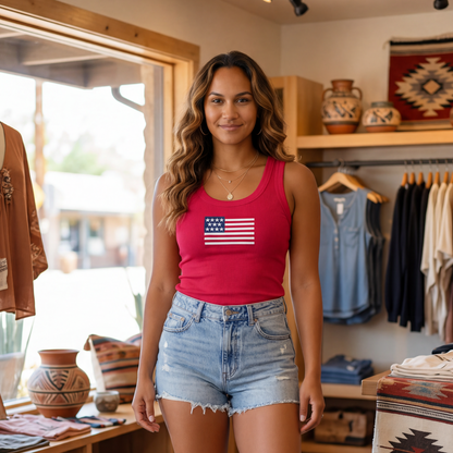 Woman wearing a red tank top with an American flag design in a store setting.