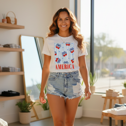 Woman wearing a t-shirt with 'America' and red, white, and blue design in a bright room.