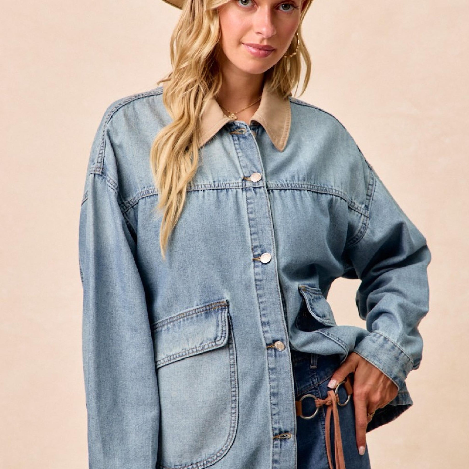 Woman wearing a denim jacket and cowboy hat on a beige background
