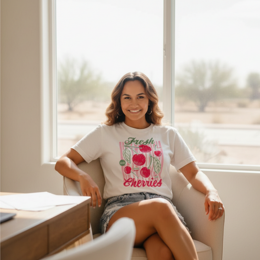Fresh Cherries graphic t-shirt worn by a women sitting in a room