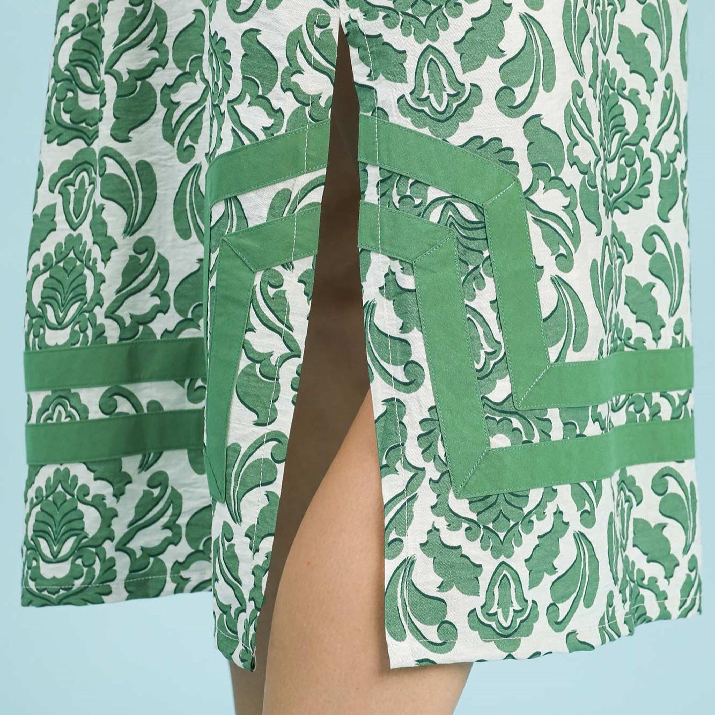 Green and white patterned garment with a blue background