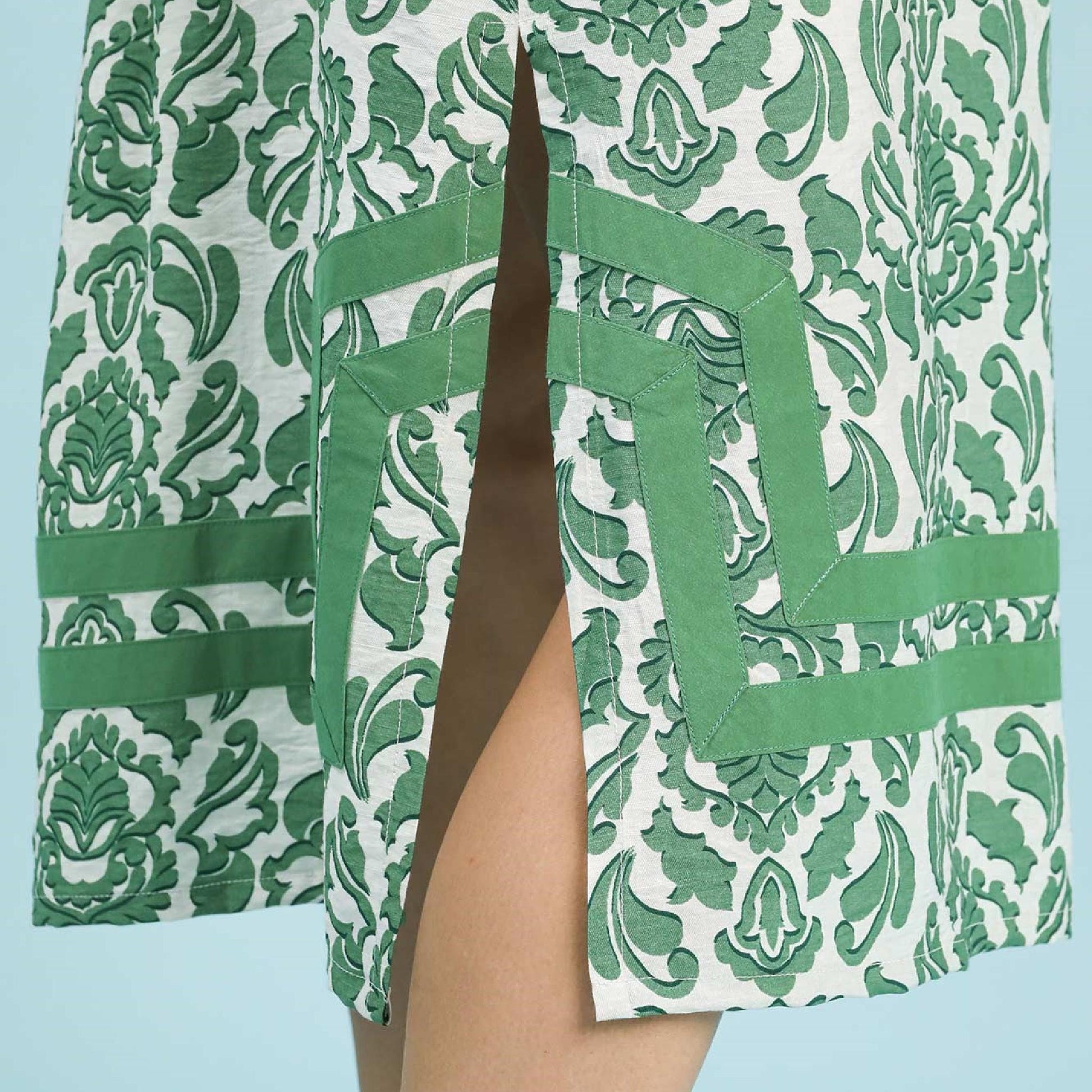 Green and white patterned garment with a blue background