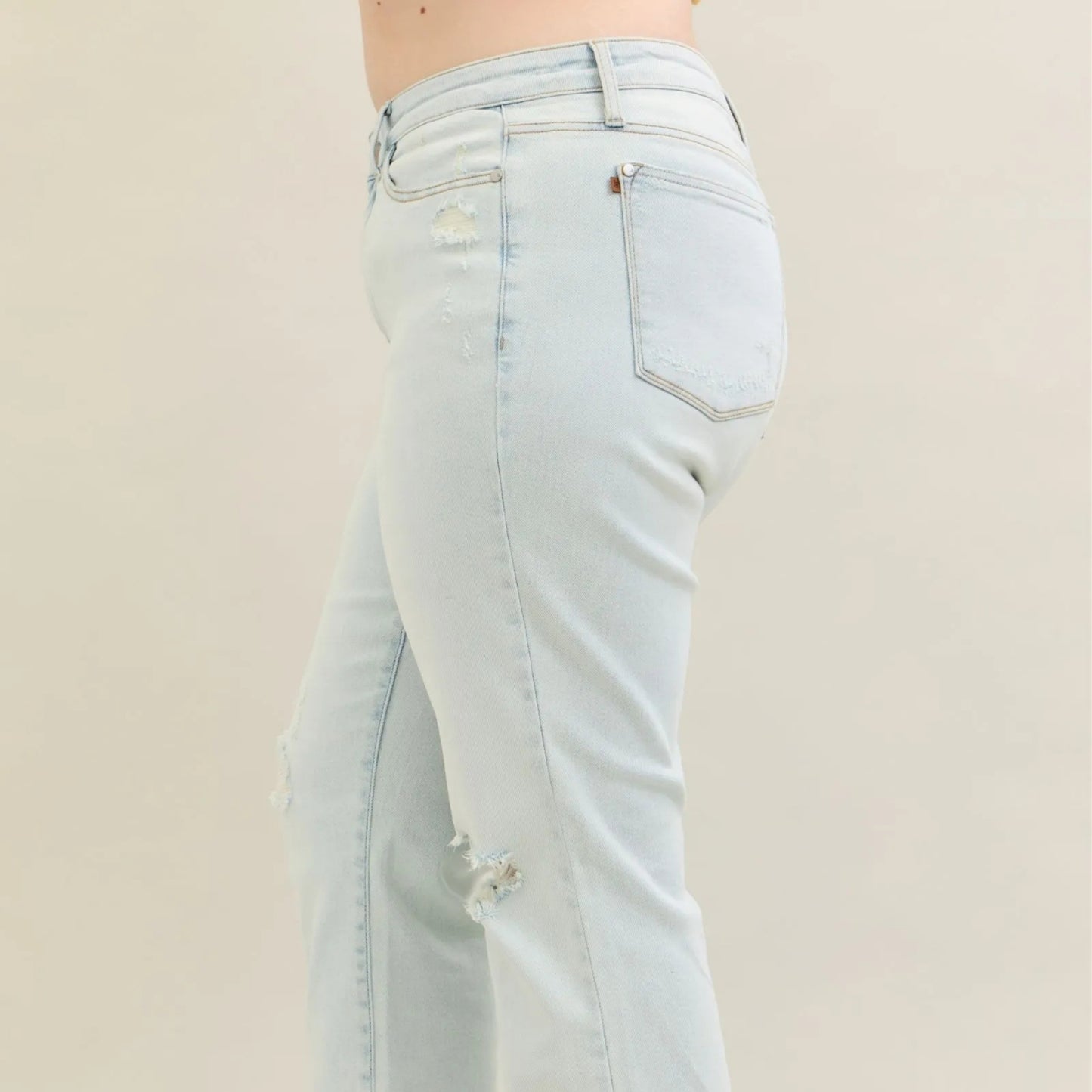Light blue jeans on a beige background