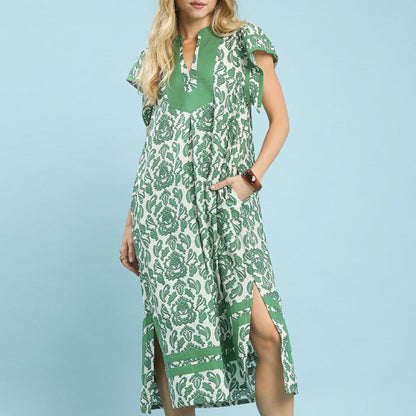 Woman wearing a green and white patterned dress against a light blue background
