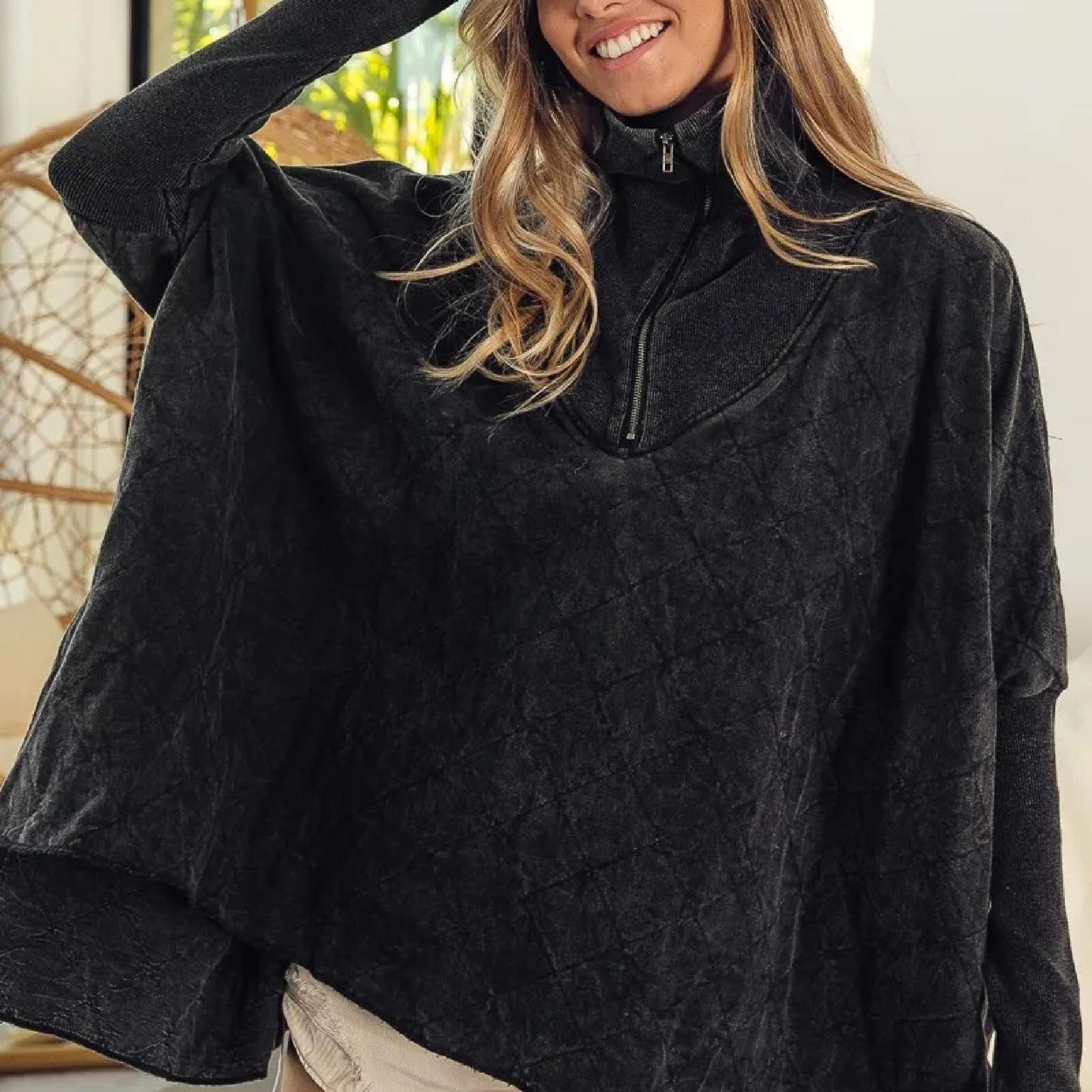 Person wearing a black fleece jacket indoors