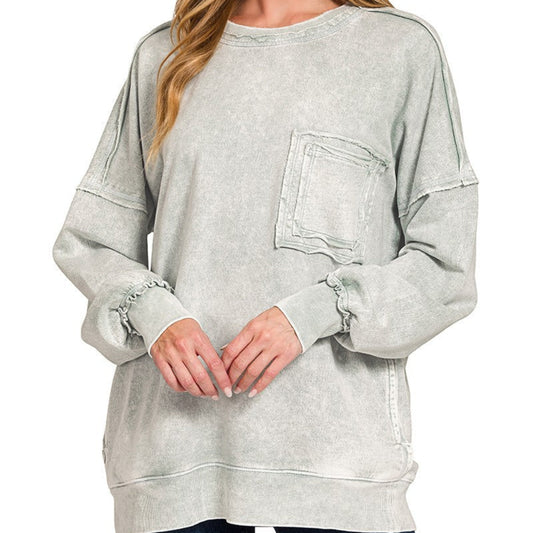 Woman wearing a light gray sweatshirt with a pocket on a white background