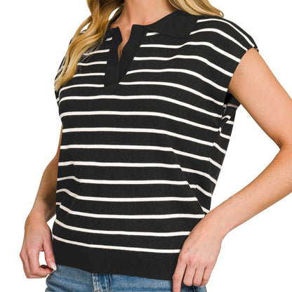 Woman wearing a black and white striped shirt with a plain background