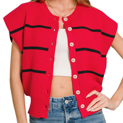 Woman wearing a red cardigan with black stripes and blue jeans on a white background