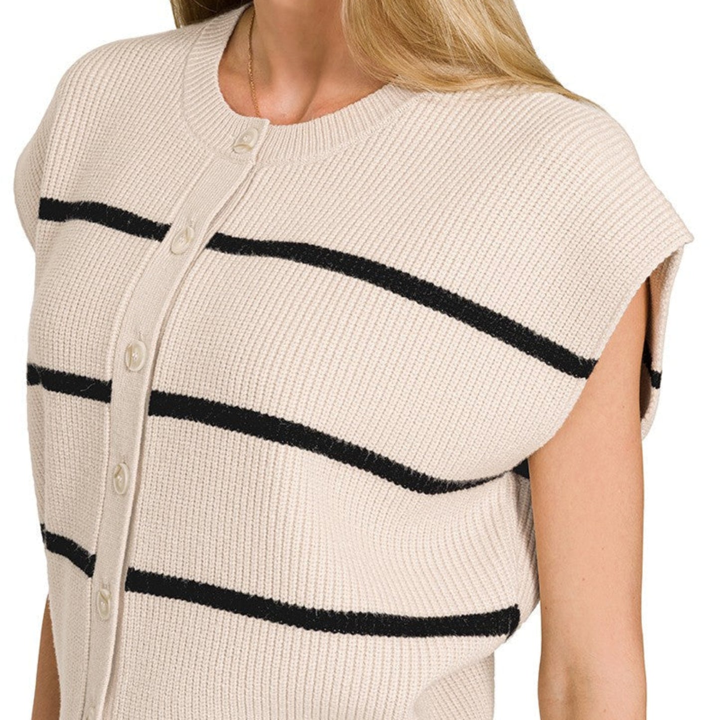 Woman wearing a sand beige cardigan with black stripes on a white background