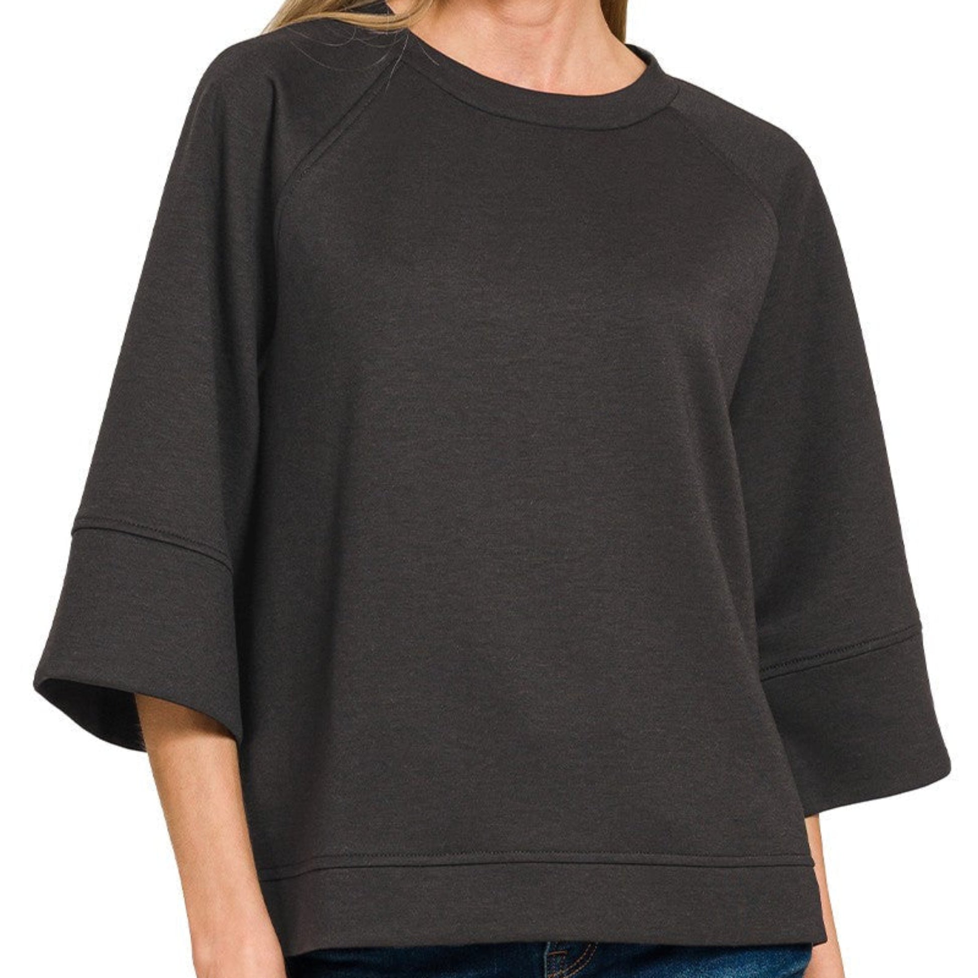 Woman wearing a black sweater on a white background