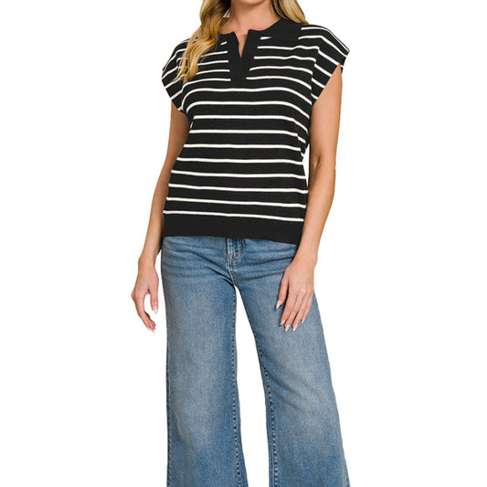 Woman wearing a black and white striped top and blue jeans on a white background