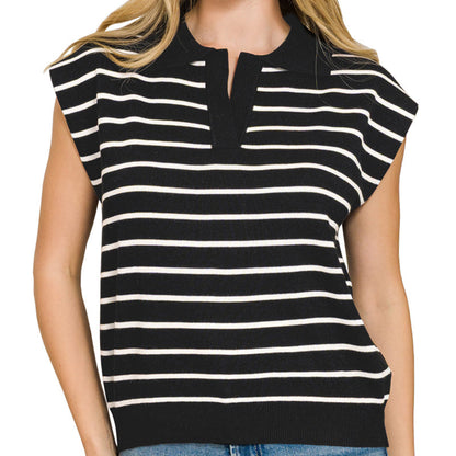Woman wearing a black and white striped sleeveless top with blue jeans on a white background