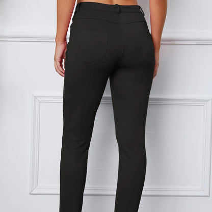 Black pants worn by a person on a white background