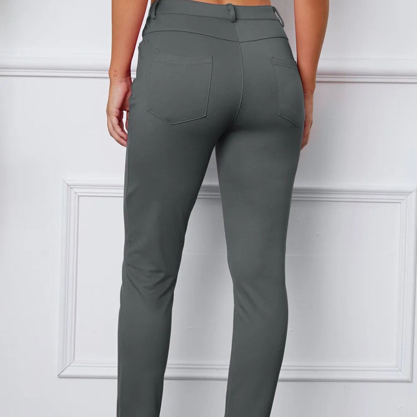 Gray pants worn by a person on a white background