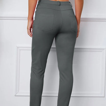 Gray pants worn by a person on a white background