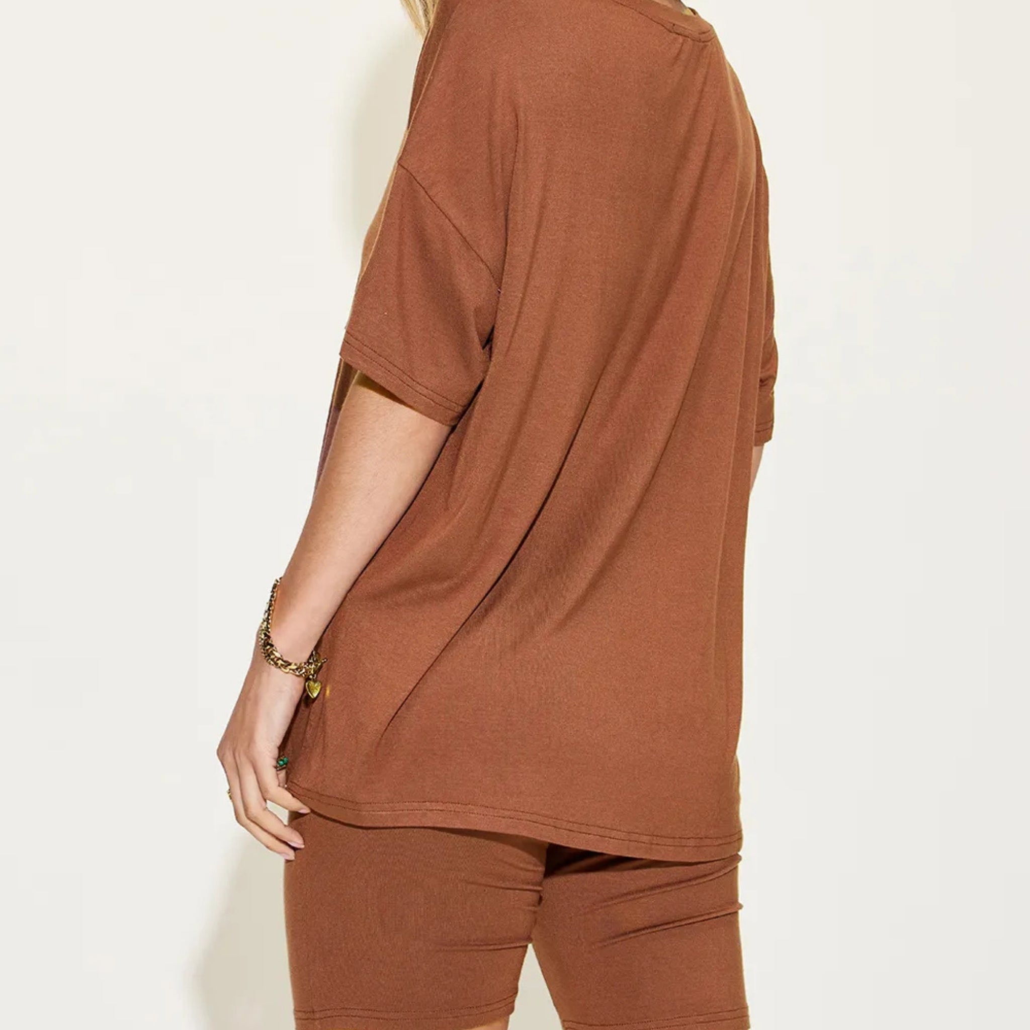 Person wearing a brown outfit on a white background