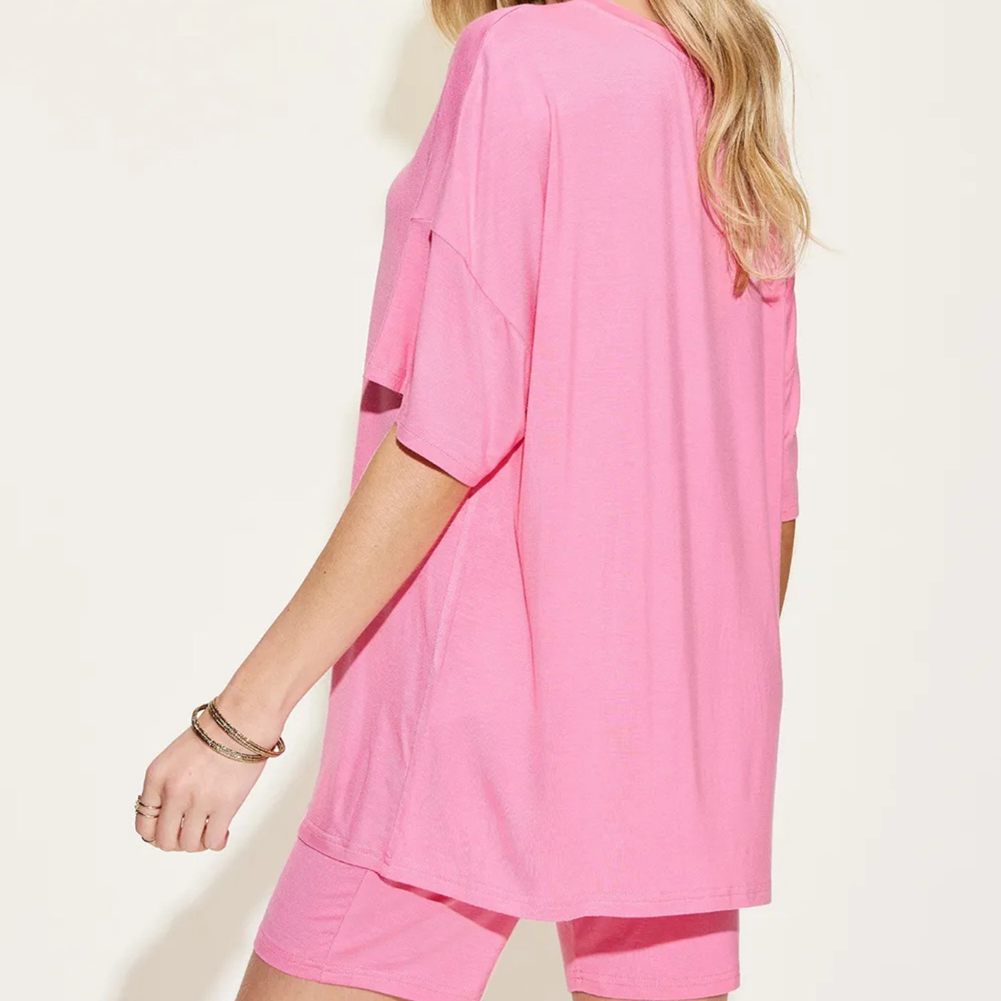 Person wearing a pink outfit on a plain background