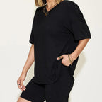 Person wearing a black outfit with a plain background