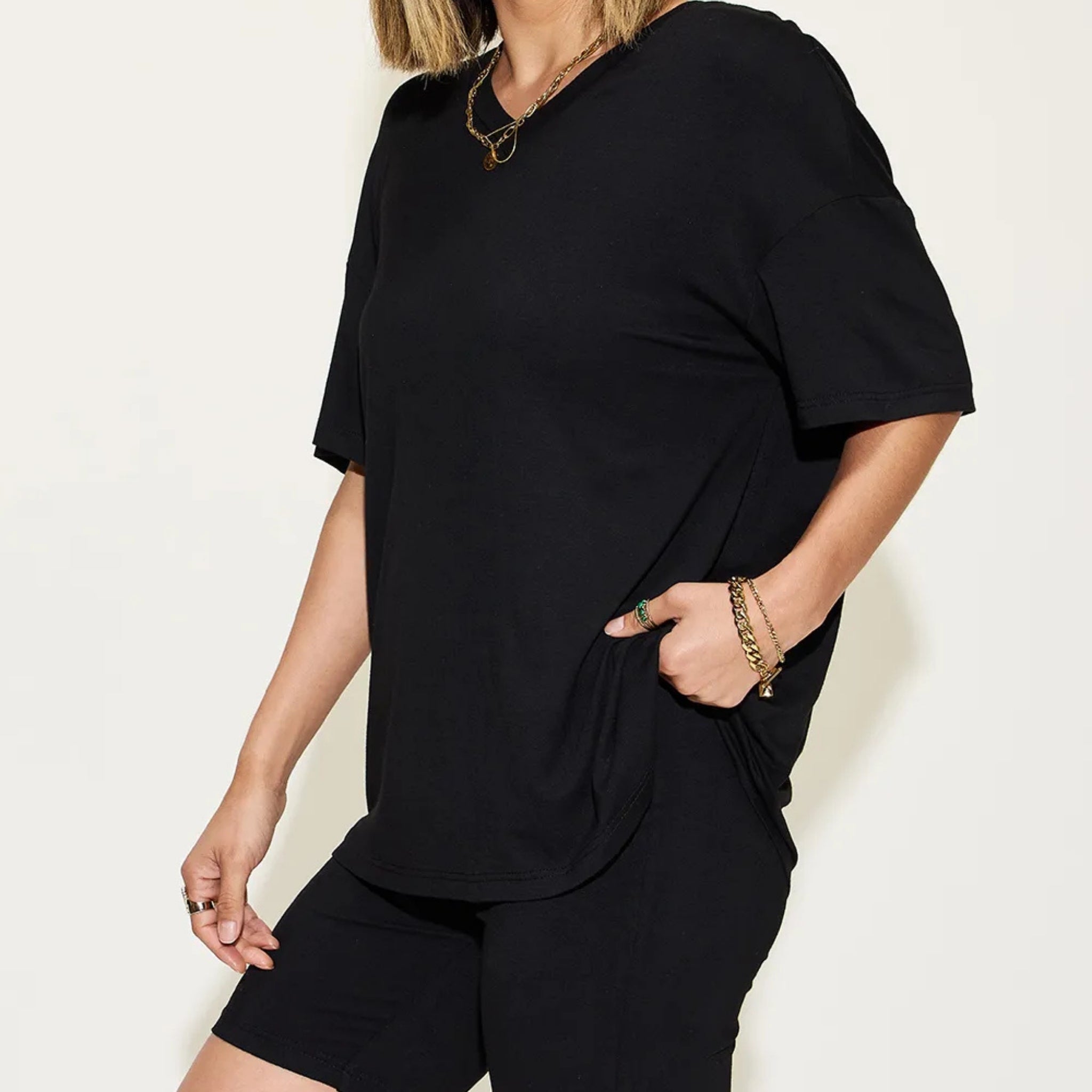 Person wearing a black outfit with a plain background