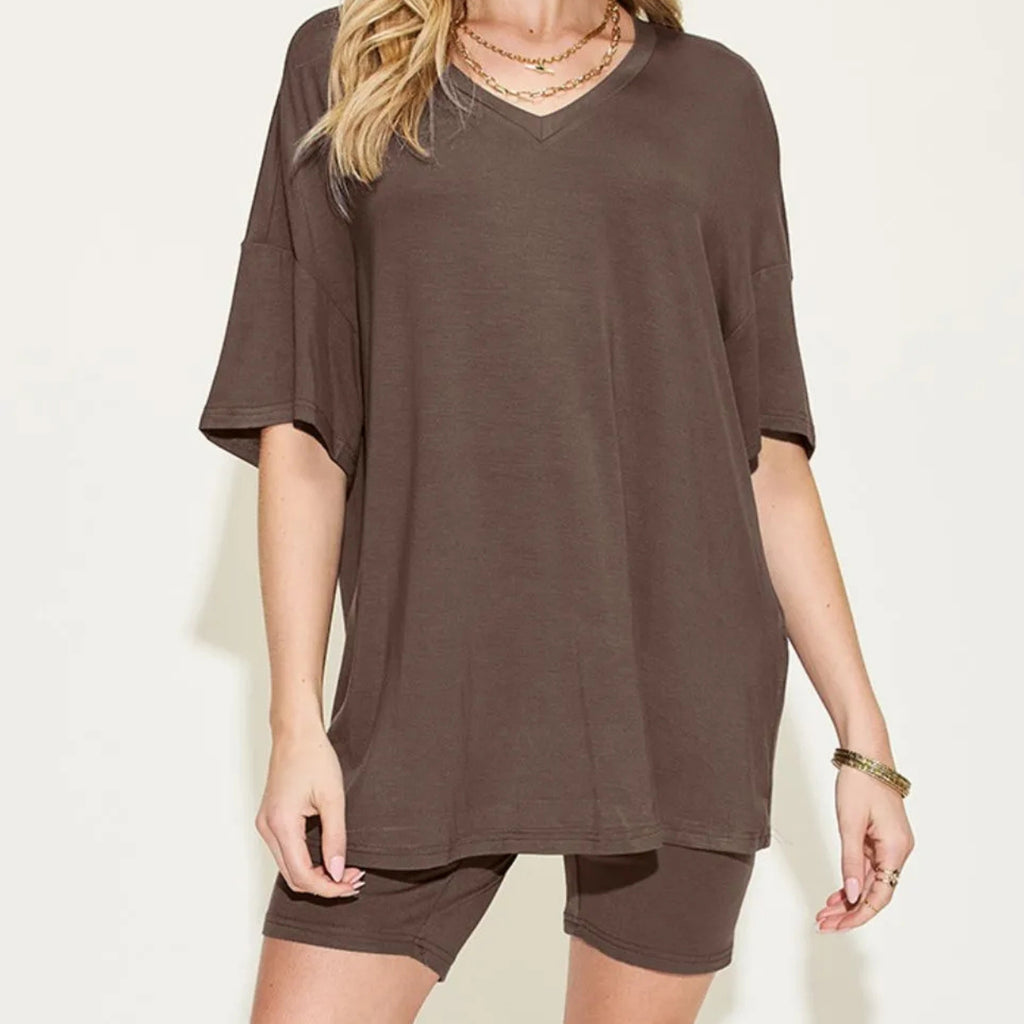 Woman wearing a chocolate oversized t-shirt and shorts set on a white background