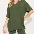 Person wearing an matcha green t-shirt and shorts on a white background