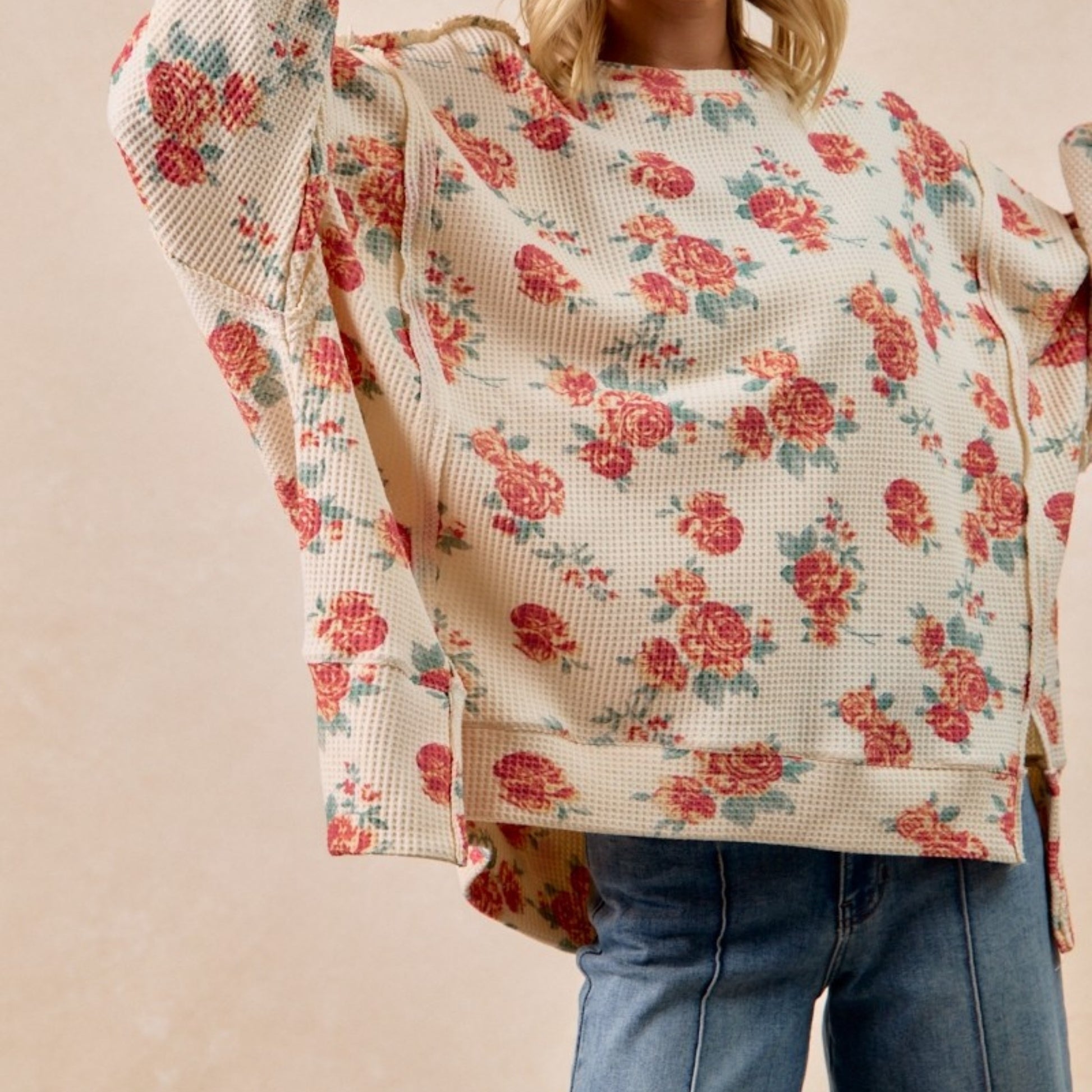 Floral patterned jacket worn by a person on a beige background