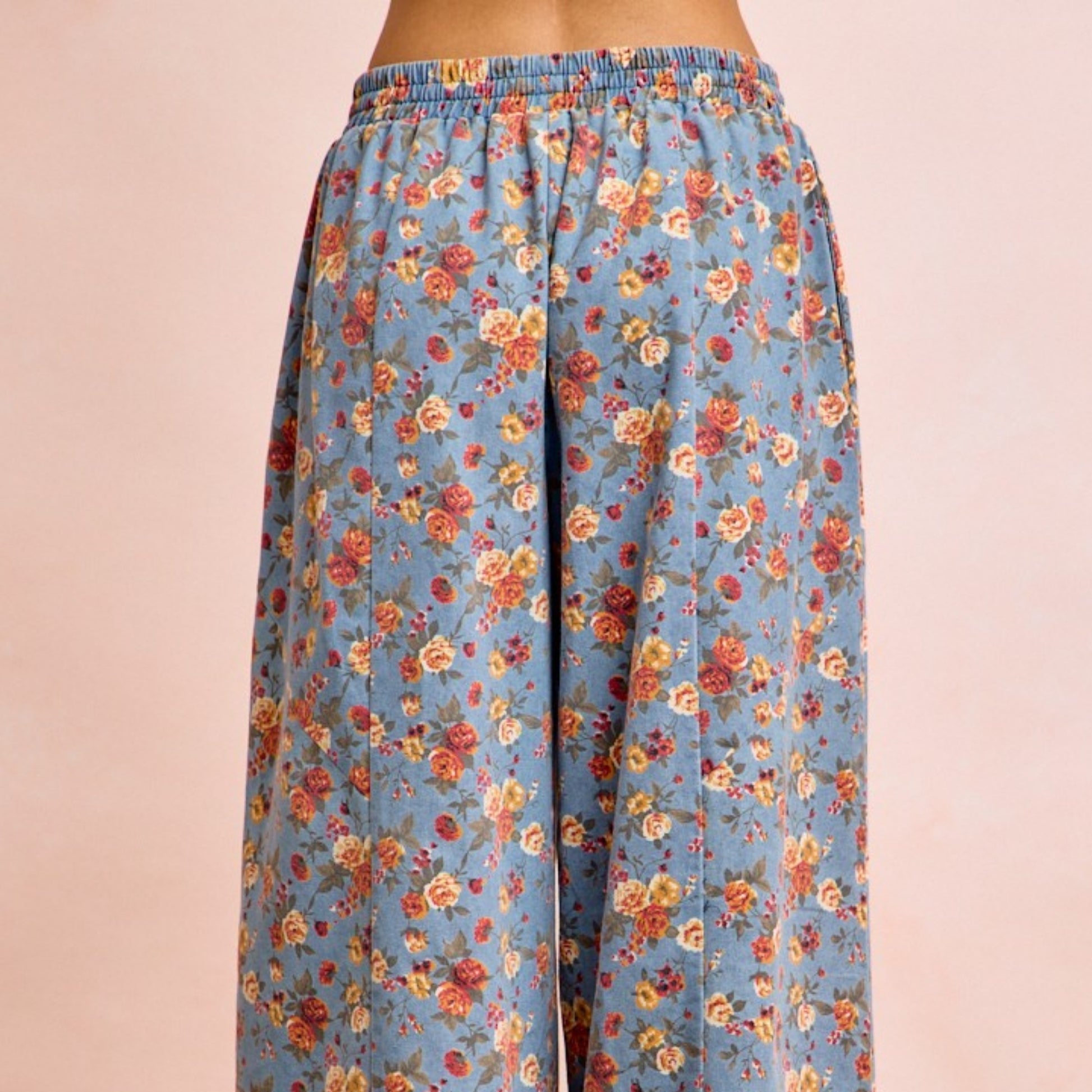 Floral patterned pants on a beige background