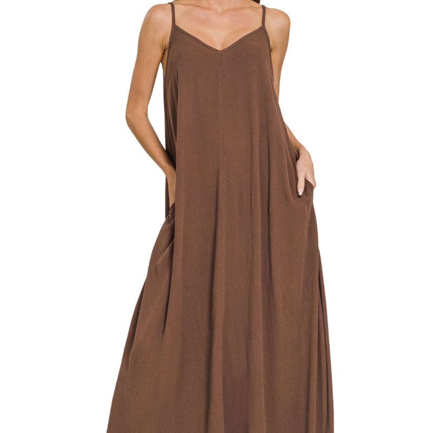 Detailed shot of the functional side pockets and realistic woven fabric on the brown dress.