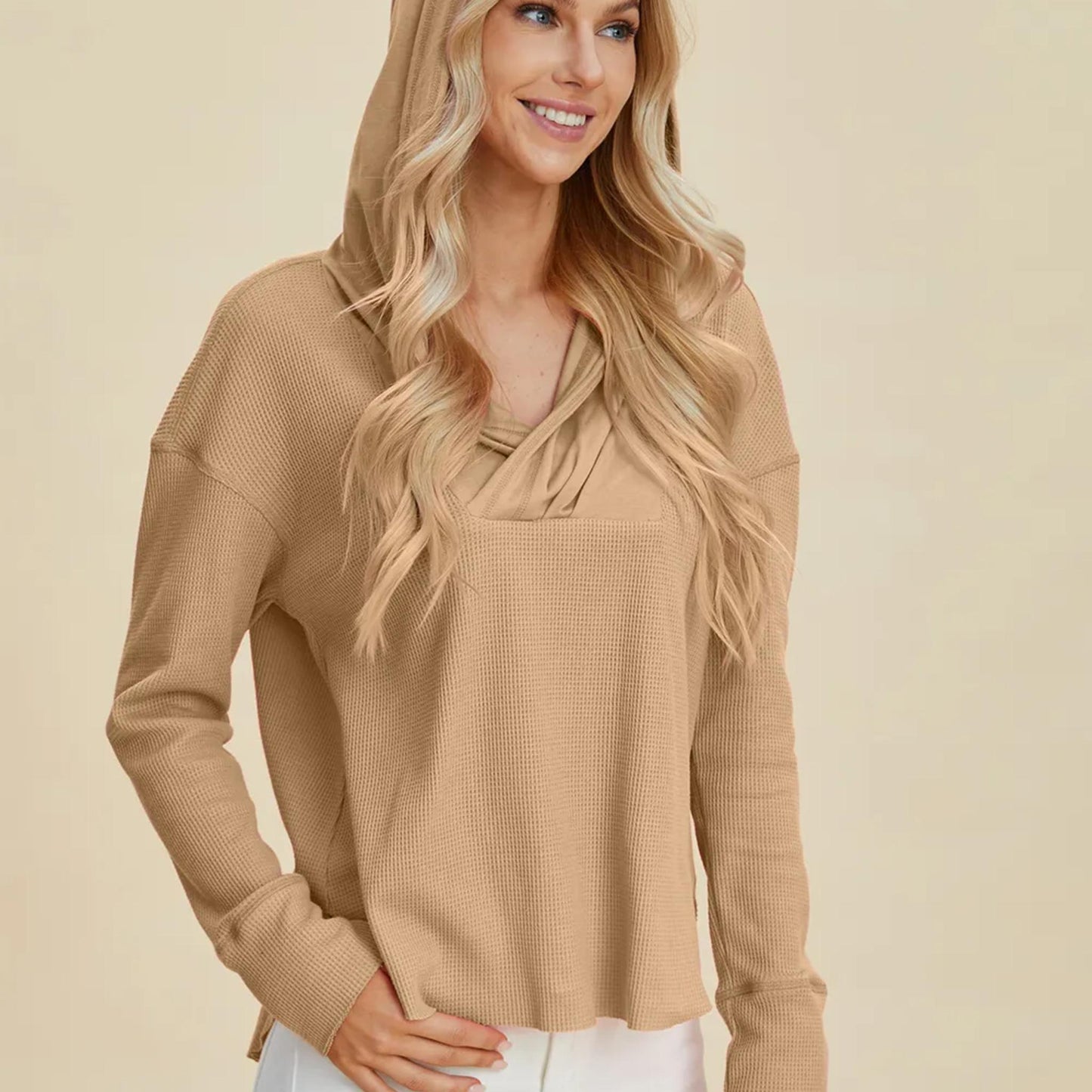 Model wearing the Camel relaxed fit pullover hoodie, showing the flattering high-low hem and dropped shoulders.