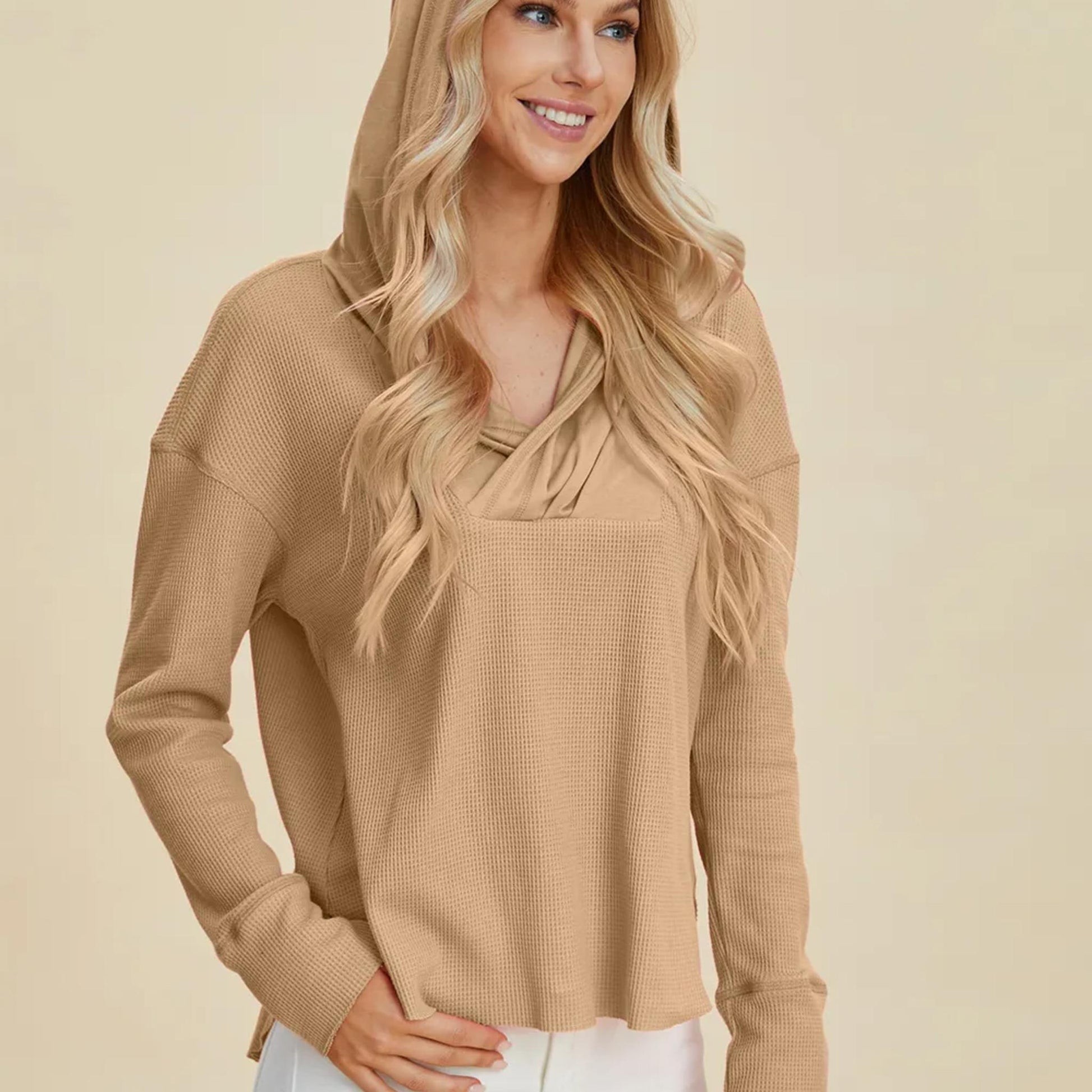 Model wearing the Camel relaxed fit pullover hoodie, showing the flattering high-low hem and dropped shoulders.