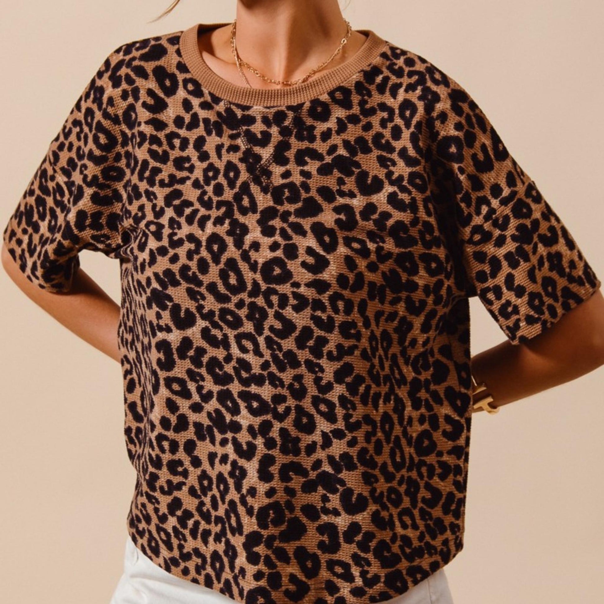 Close-up of the textured waffle knit fabric and coffee leopard print on the SO ME top.