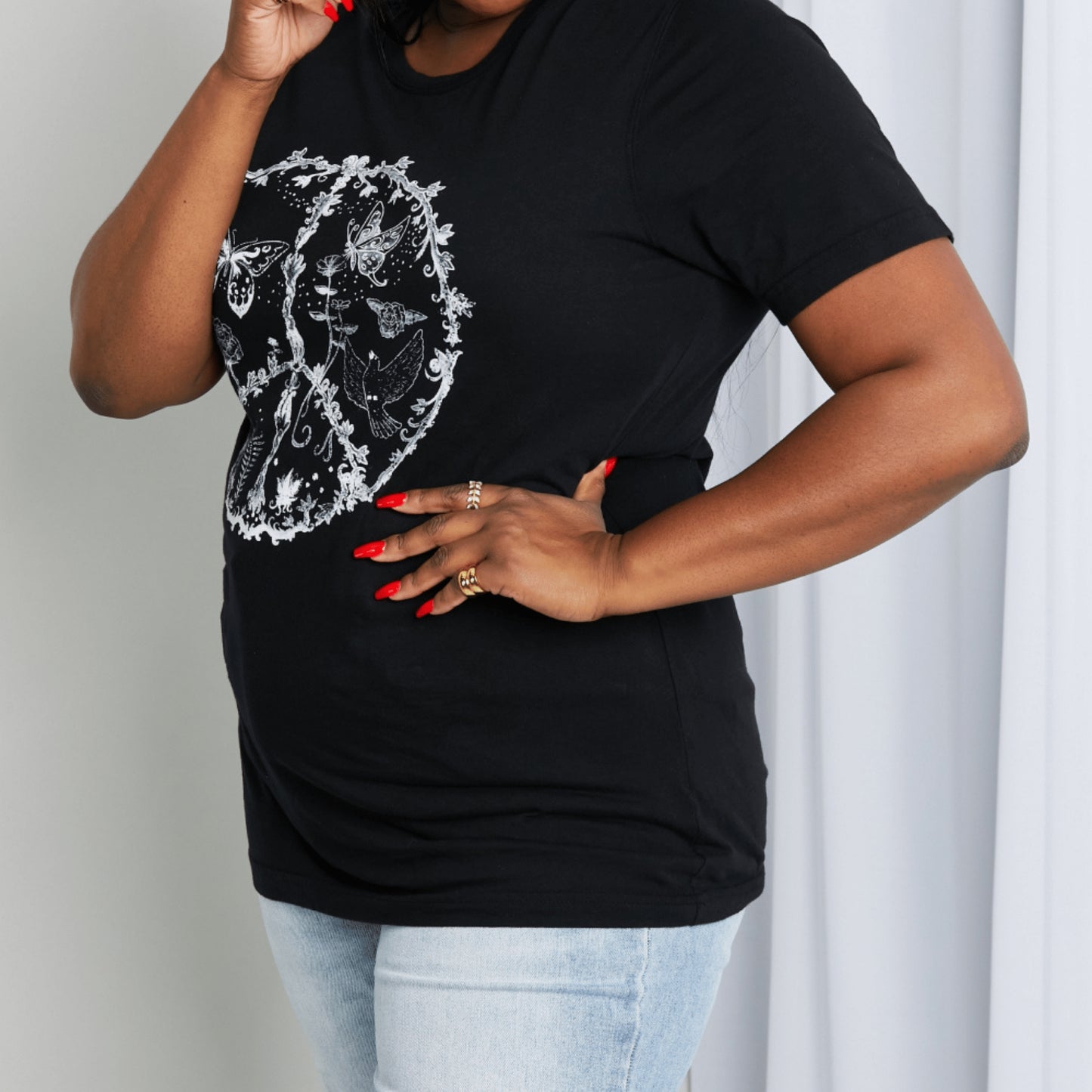 Detailed showcase of the 100% cotton fabric and screen-printed peace symbol design.