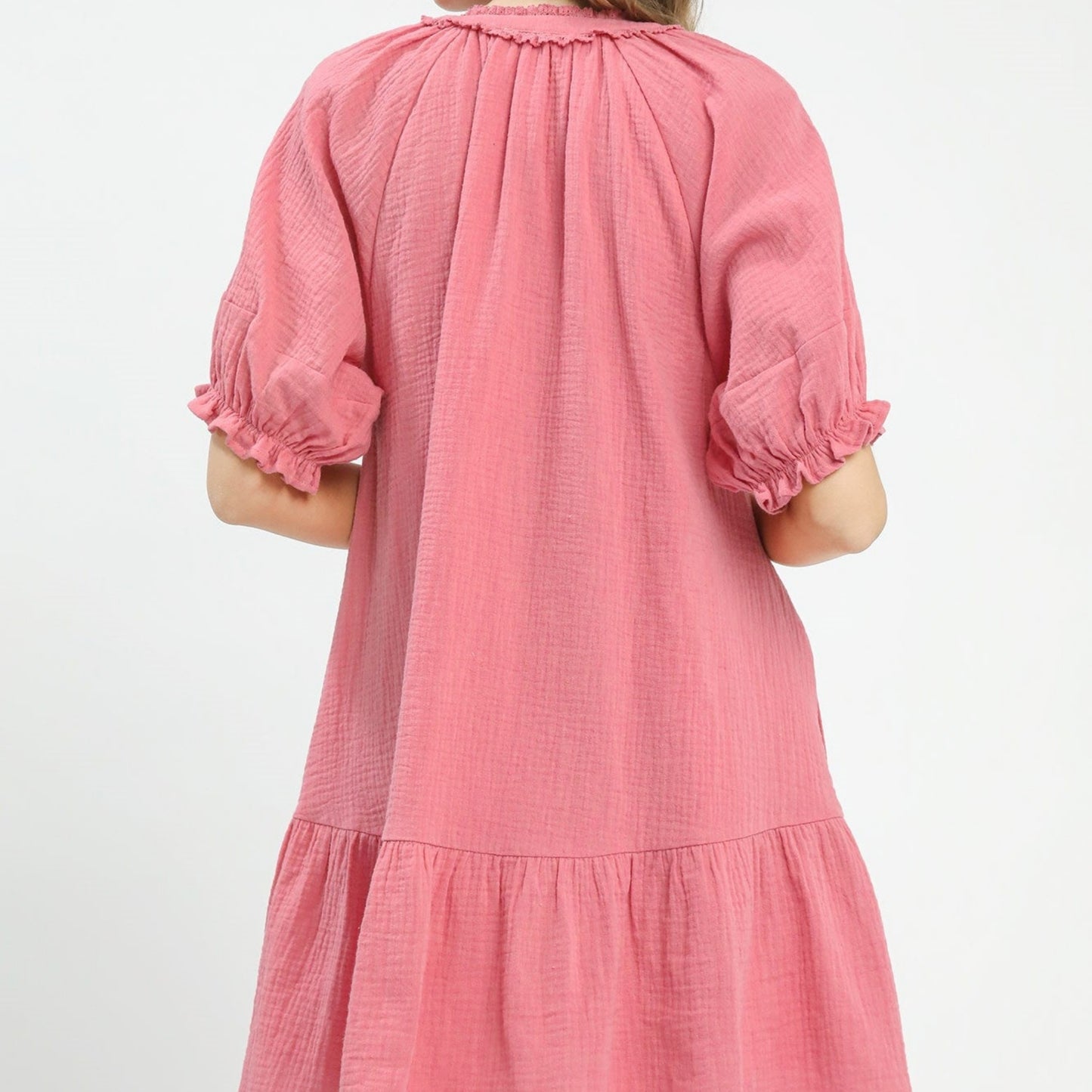 Pink dress with puff sleeves on a white background
