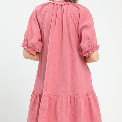 Pink dress with puff sleeves on a white background