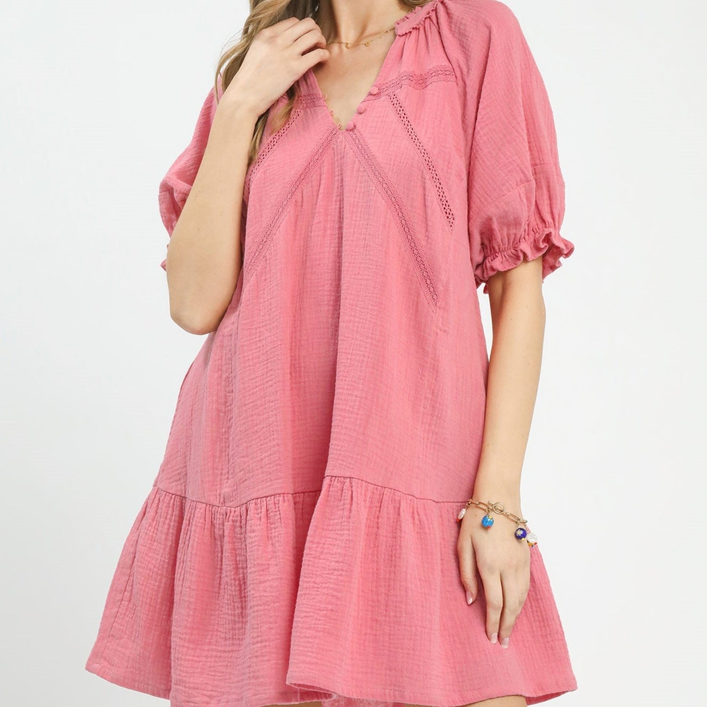 Pink dress worn by a person on a white background