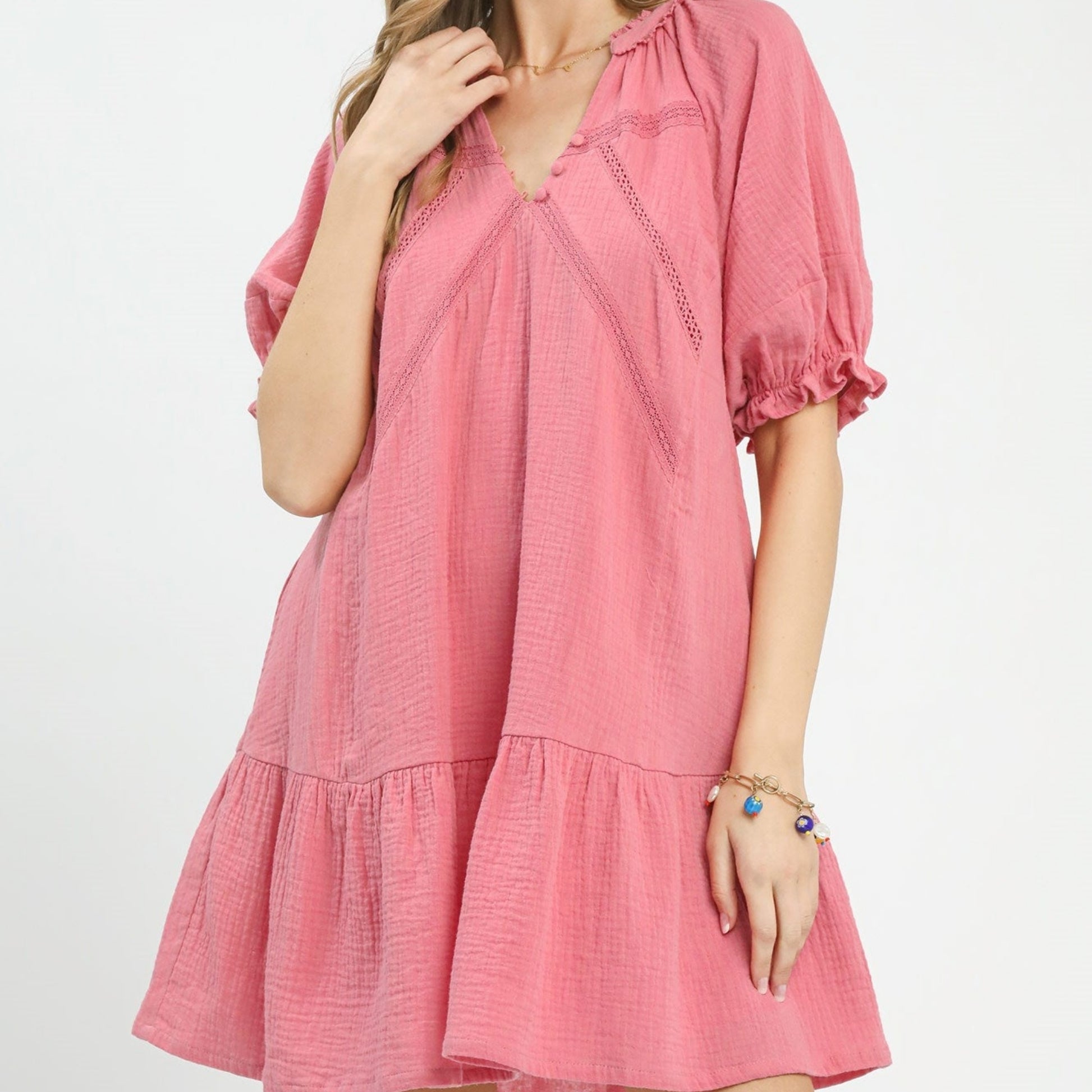 Pink dress worn by a person on a white background