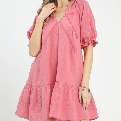 Pink dress worn by a person on a white background