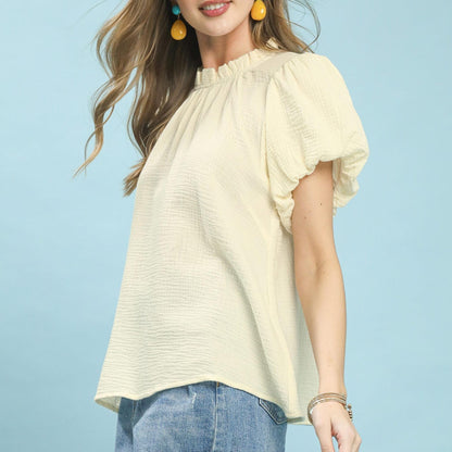Lifestyle view of the Umgee gauze top paired with denim for a bohemian look.
