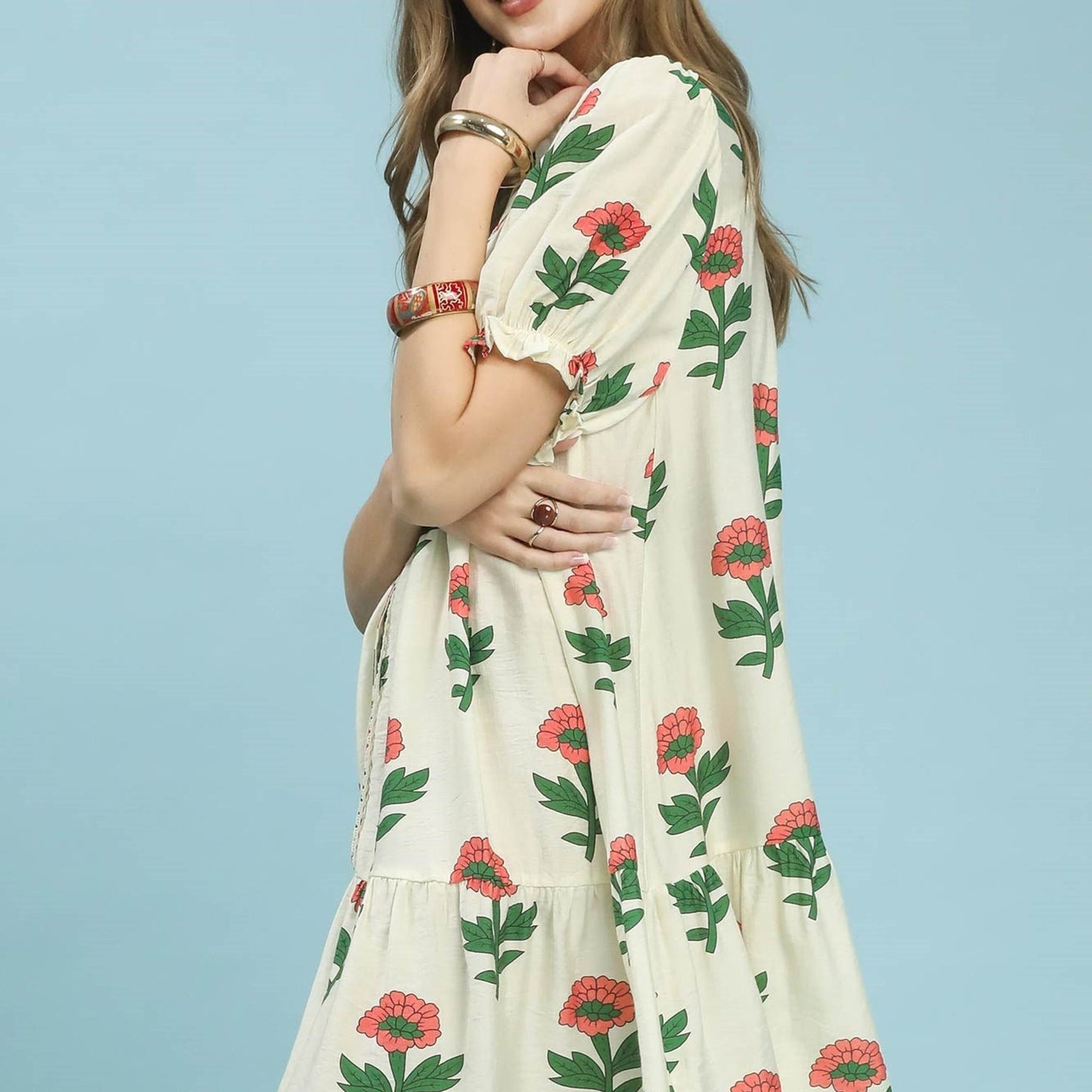 Lifestyle view of a model wearing the Umgee floral babydoll dress for a breezy summer look.