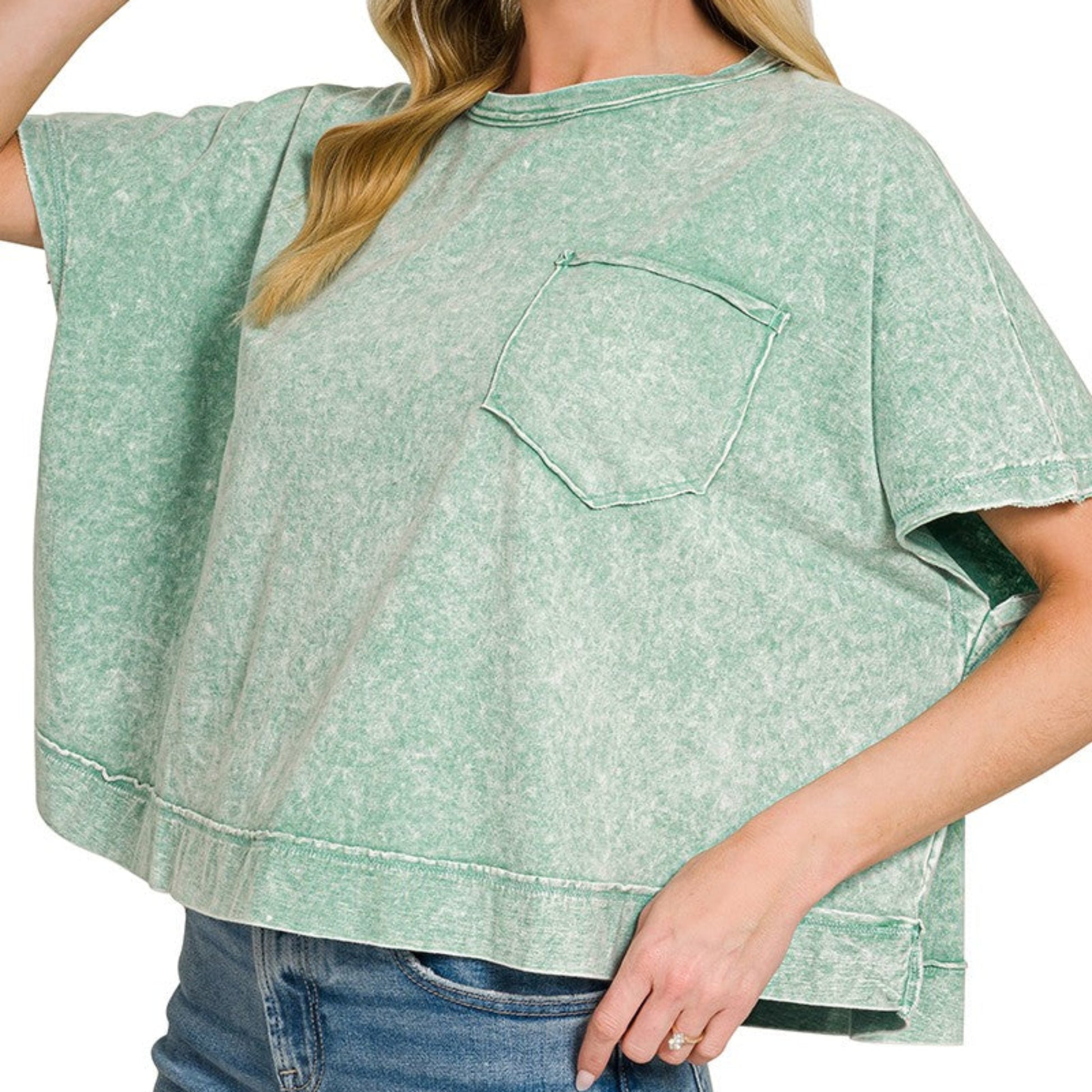 Detailed view of the vintage halo wash finish and pocket on the dark green Zenana top.
