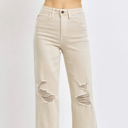 Front view of distressed wide-leg jeans in bone wash.