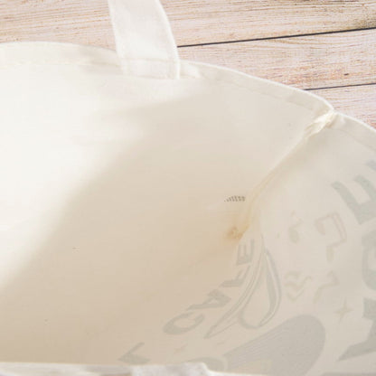 View of the roomy interior and lightweight fabric of the vinyl cafe tote bag