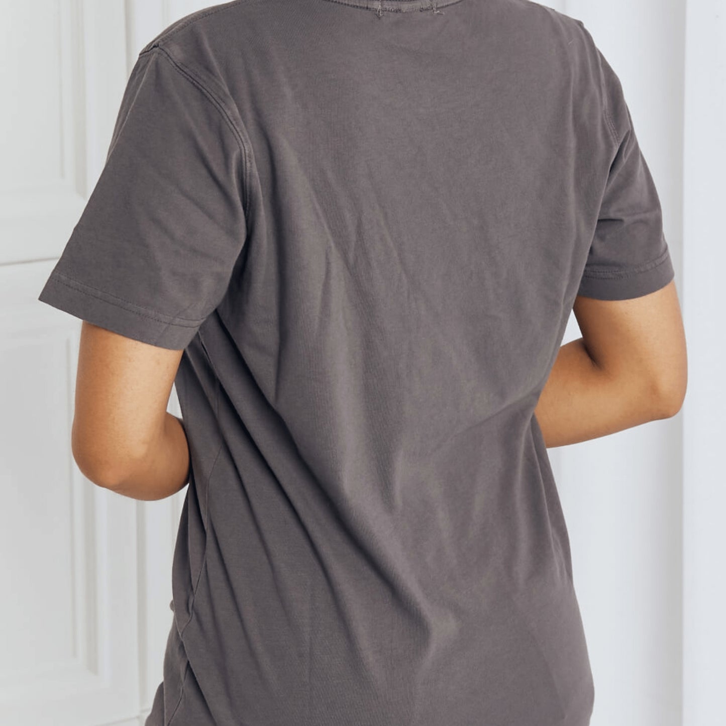 Back view of the charcoal eagle tee paired with light blue jeans.