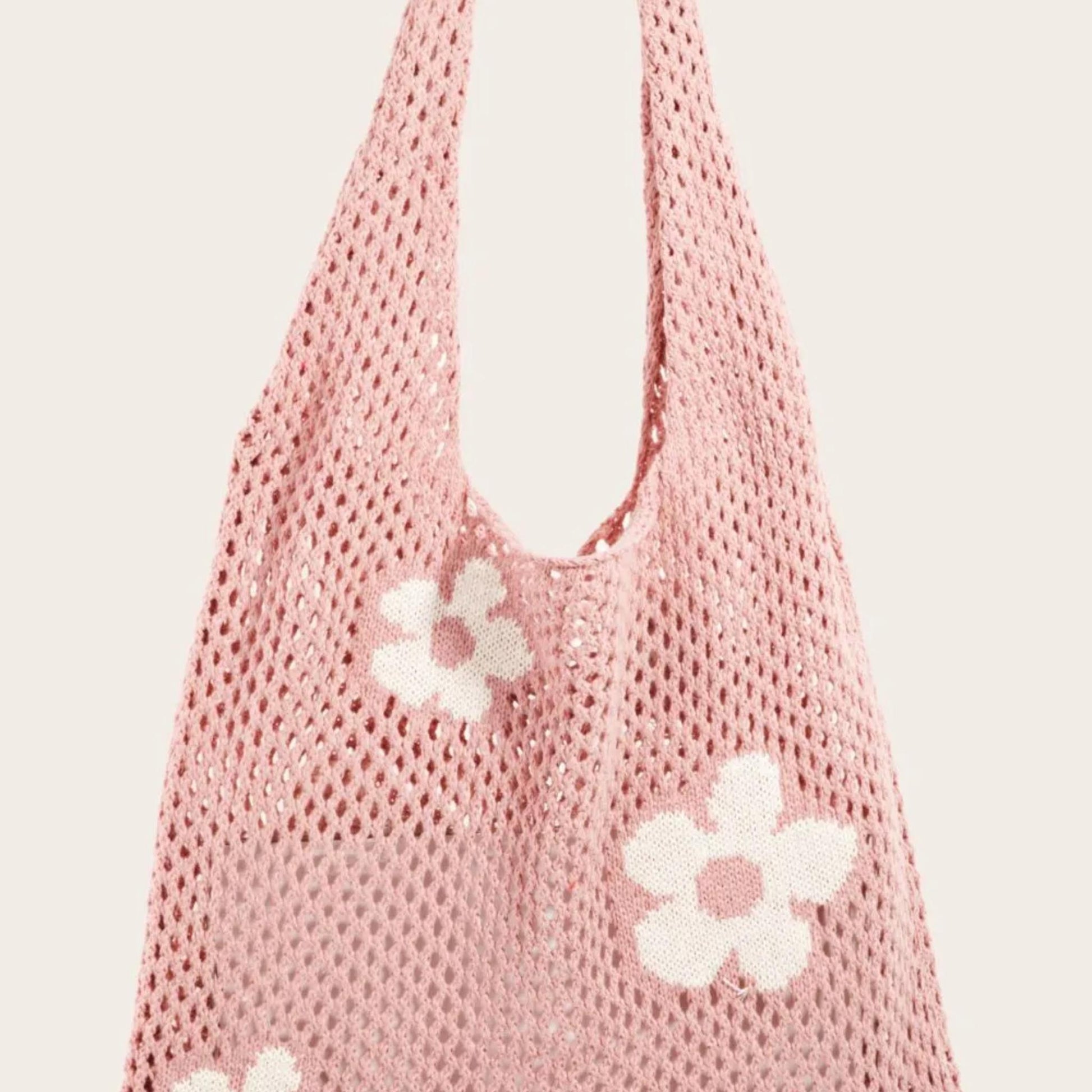 Front view of the Fame Flower knitted crochet shoulder bag in dusty pink with white floral appliques.