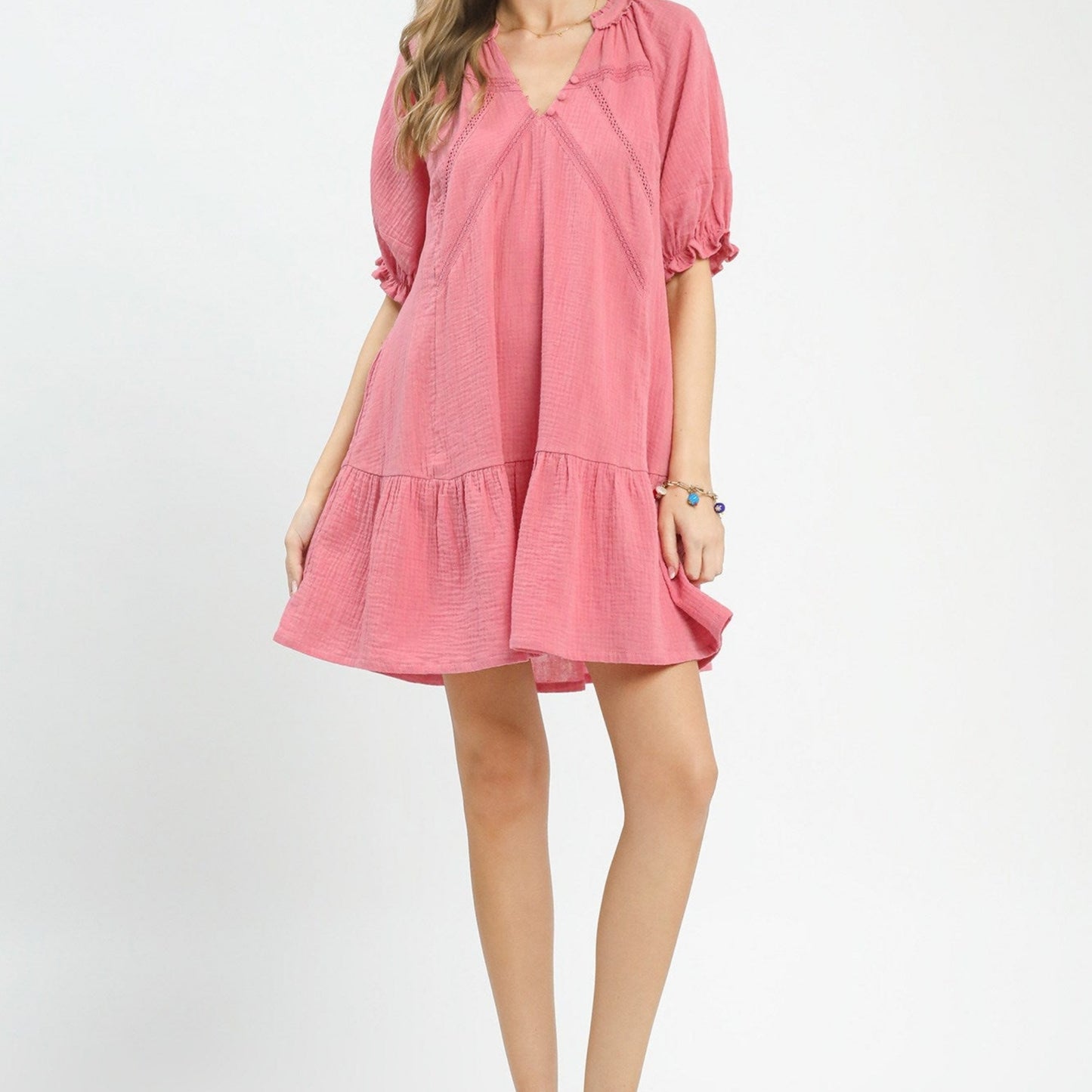 Pink dress worn by a person on a white background