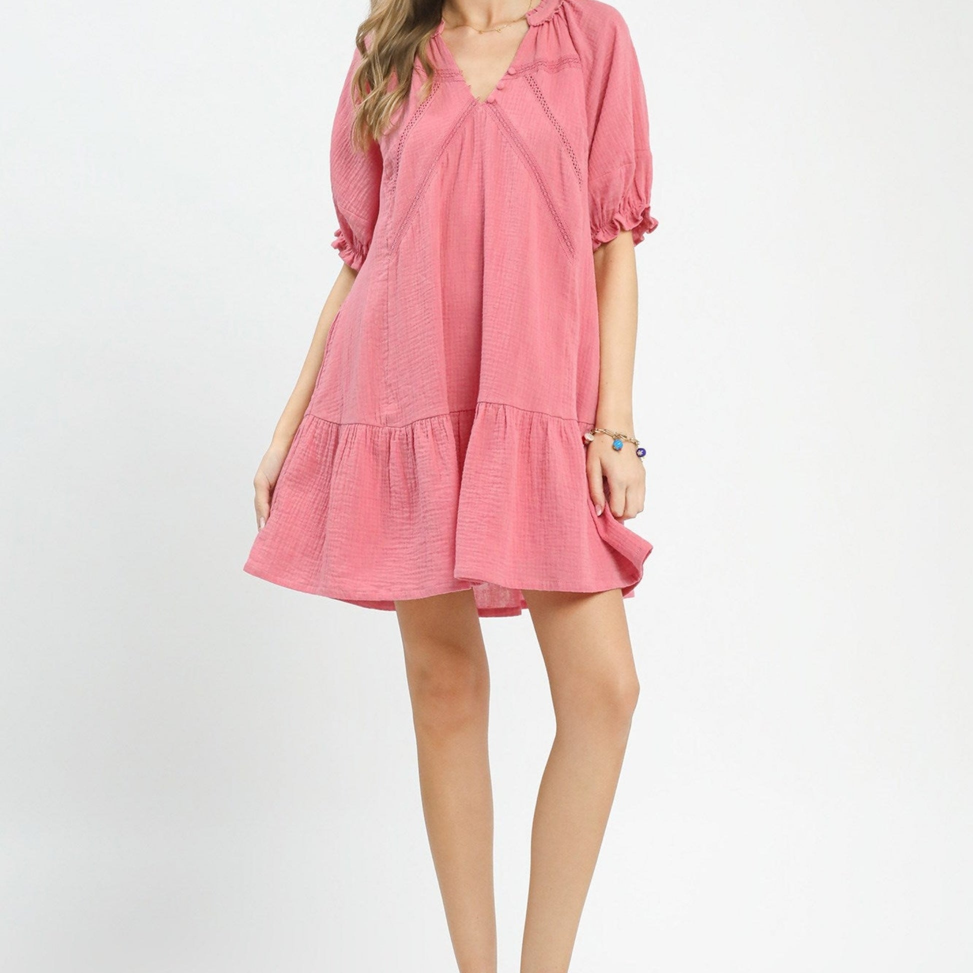 Pink dress worn by a person on a white background